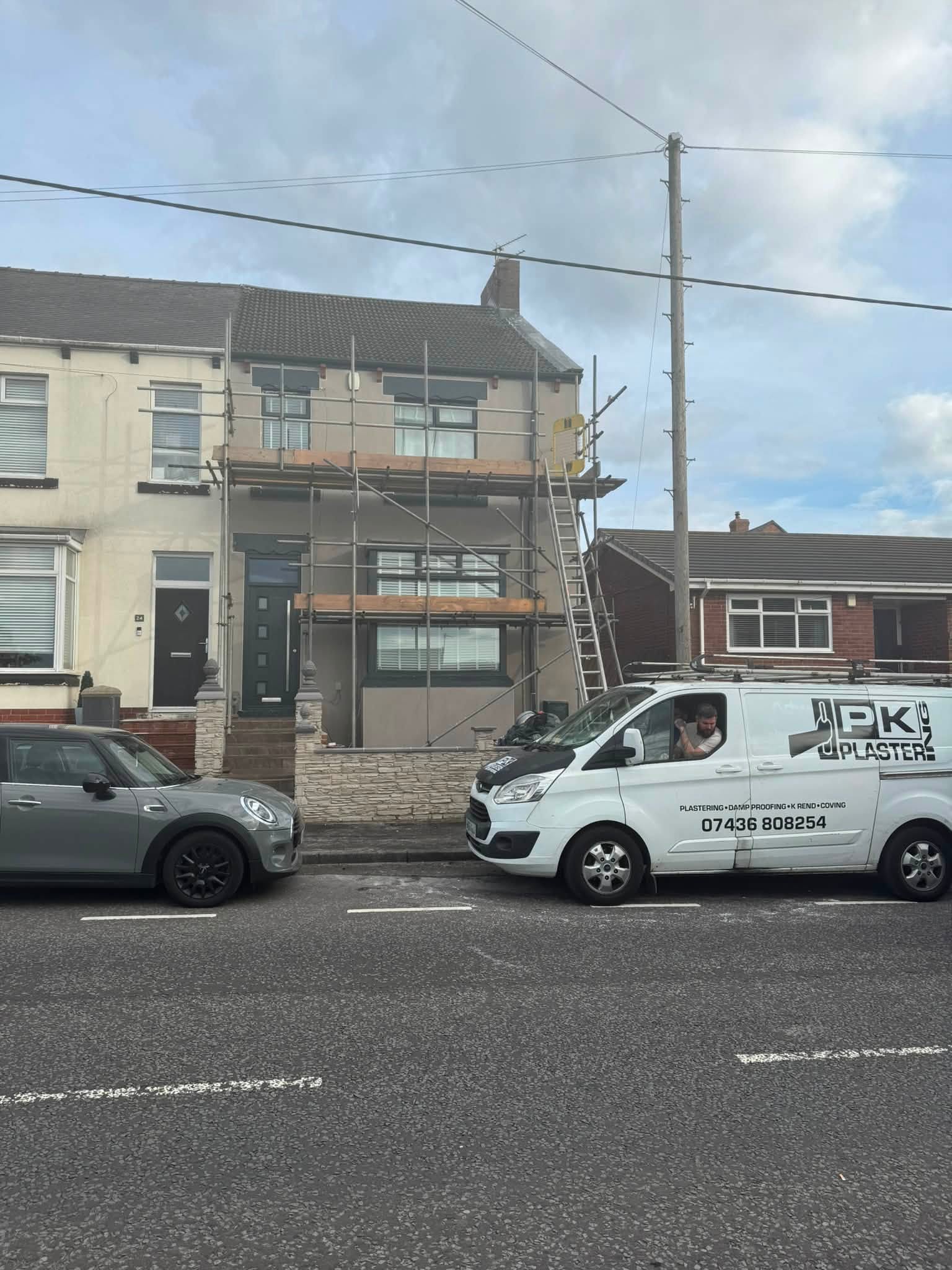 PK Plastering van outside a house being rendered