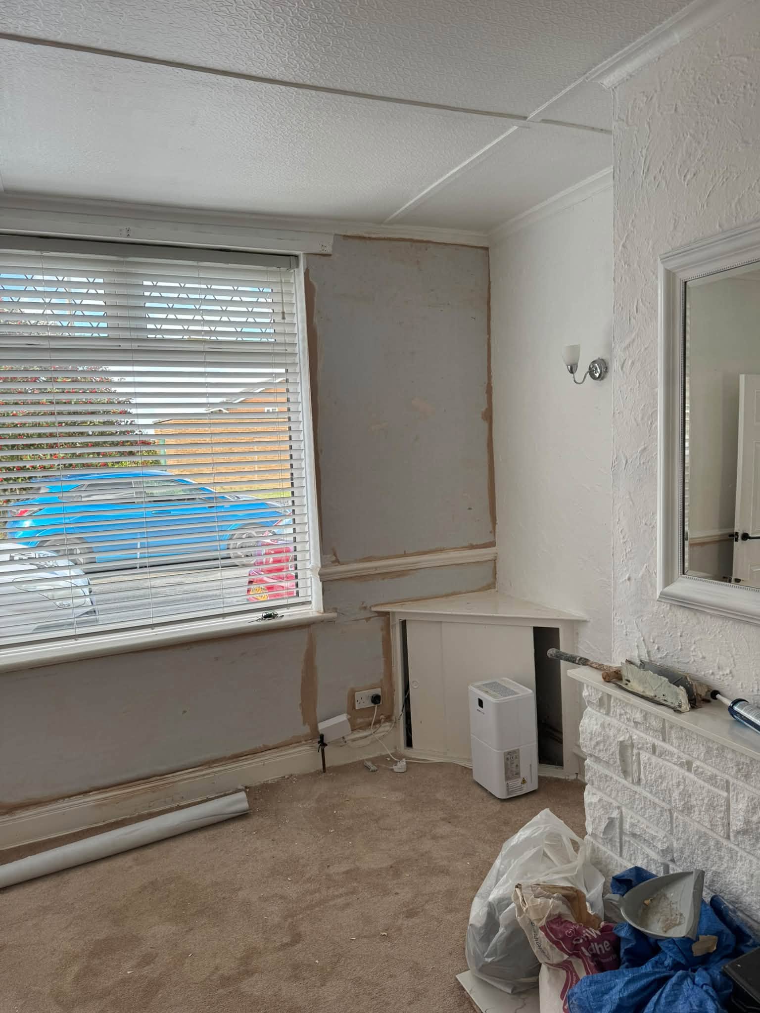 Living room wall opened up for a plaster repair