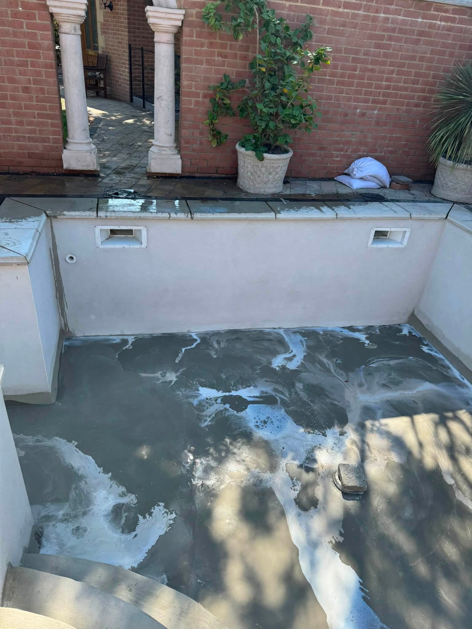 Pool with a fresh white render and a newly laid base